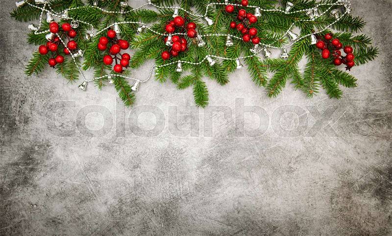 Christmas decoration with red berries and silver garland. Vintage style toned picture, stock photo