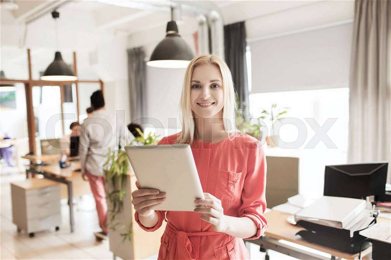 Business, startup and people concept - happy businesswoman or creative female office worker with tablet pc computer, stock photo