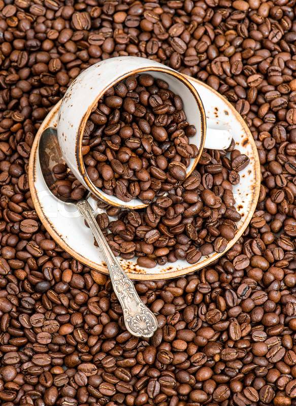 Food and drinks. Black coffee on coffee beans background, stock photo