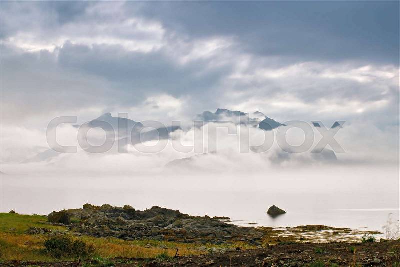 Coast of Norway sea in clouds of fog. Cloudy Nordic day on Lofoten islands, stock photo