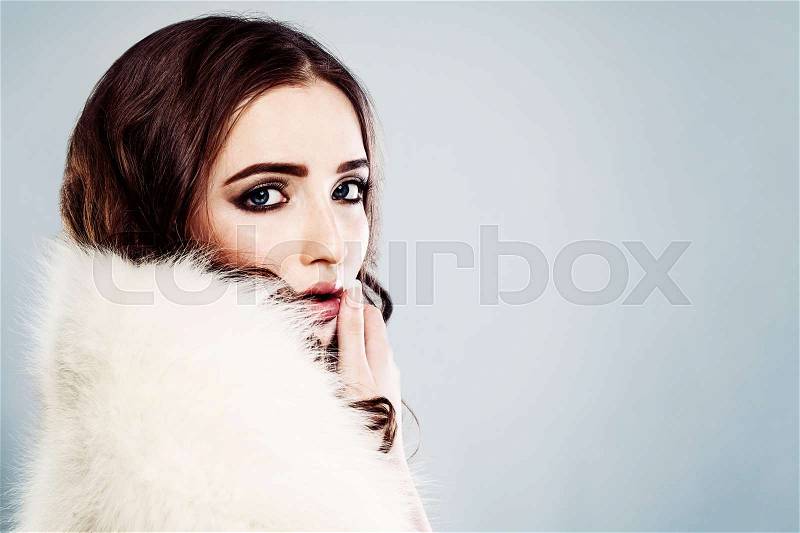 Fashion Portrait of Beautiful Woman Model in White Winter Fur, stock photo