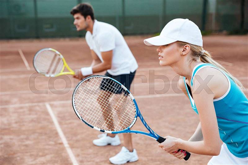 Side view of tennis woman and man on court, stock photo