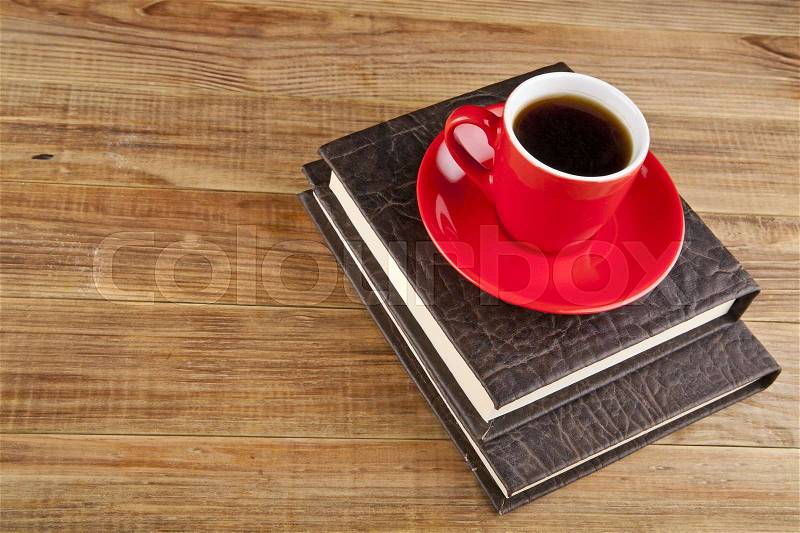 Books and coffee Cup on wooden background, stock photo