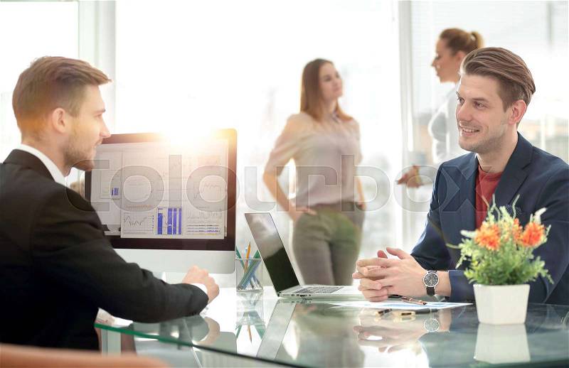 Business partners discussing in meeting hall with their collegue, stock photo