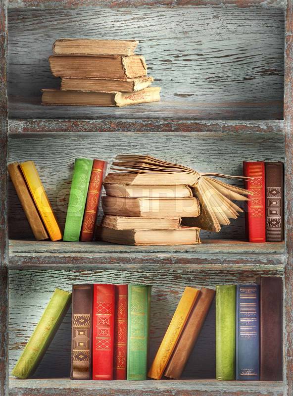Wooden shelves with books, stock photo