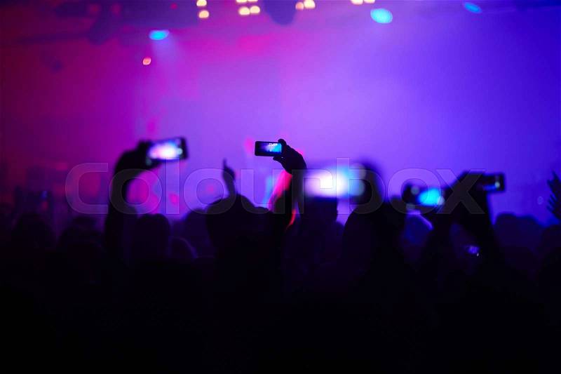 Hands of young people with smartphones recording pop concert, stock photo