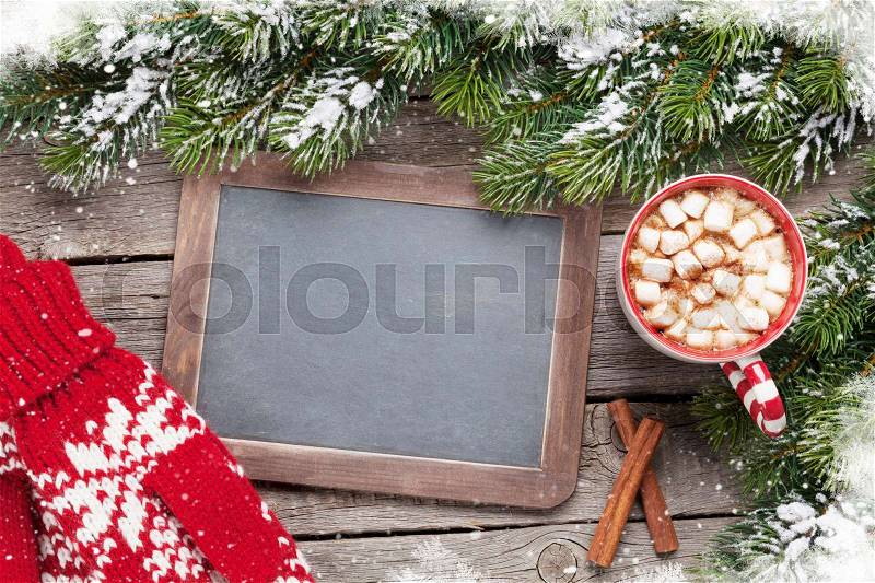 Christmas fir tree, hot chocolate, mittens and chalkboard for your greetings. Top view with copyspace, stock photo