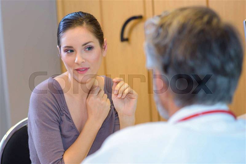 Female patient questioning doctor, stock photo