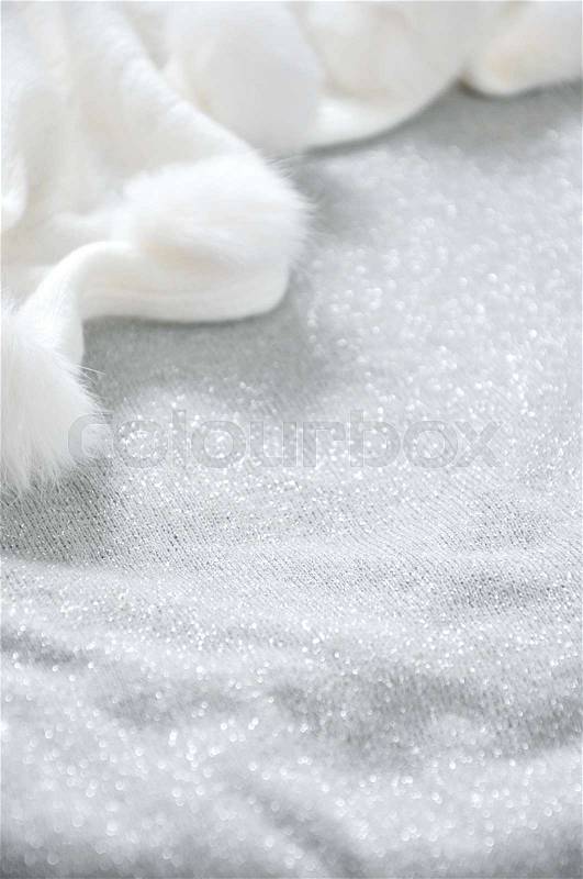 Glitter grey background with white puffy scarf, stock photo
