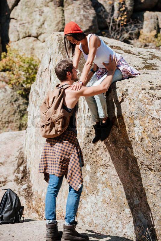 Man and woman teamwork climbing or hiking in summer, stock photo