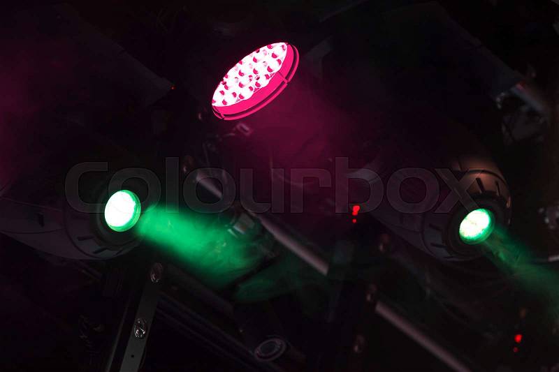 Colorful spot lights mounted above the stage, stock photo