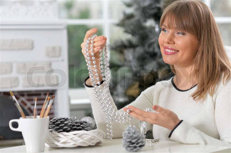 Portrait of smiling mature woman with hand made decorations, stock photo