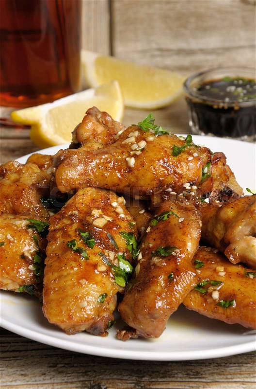 Fried chicken wings in ginger garlic marinade with herbs, stock photo