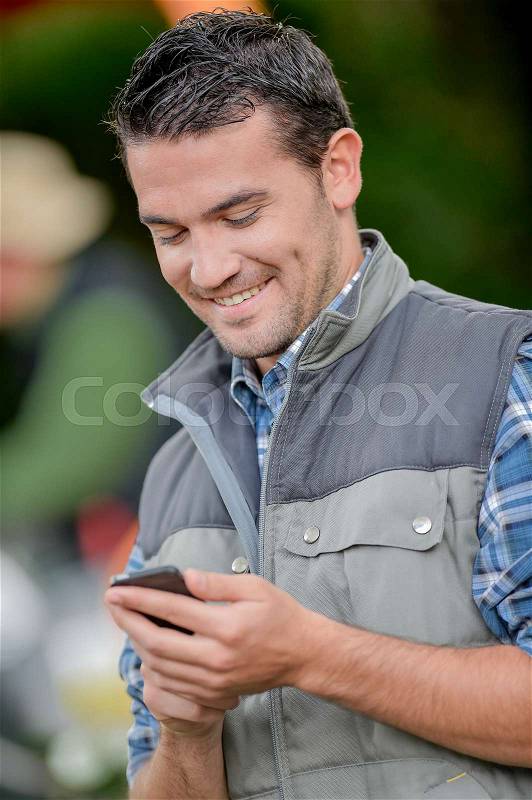 Young man checking his phone, stock photo