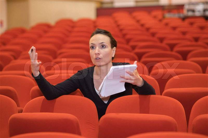 Woman directing in a theater, stock photo