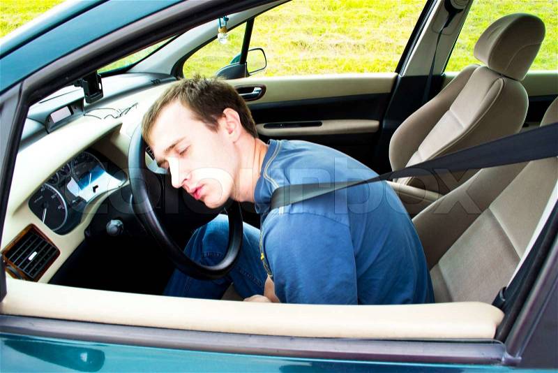 Man sleeps in a car, stock photo