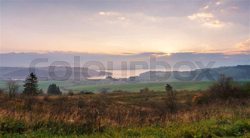 Slovakia autumn sunny morning panorama. Rural fall mountain scene. Village in valley, stock photo