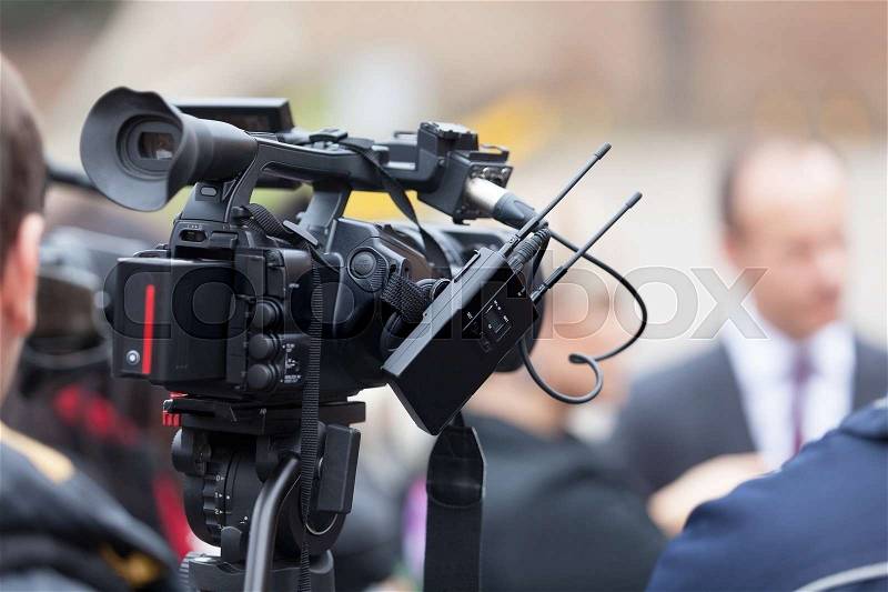 Filming an media event with a video camera. Press conference, stock photo