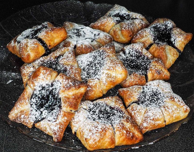 Danish pastry with blueberry jam filling with white powdered sugar, stock photo