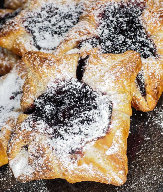 Danish pastry with blueberry jam filling with white powdered sugar, stock photo