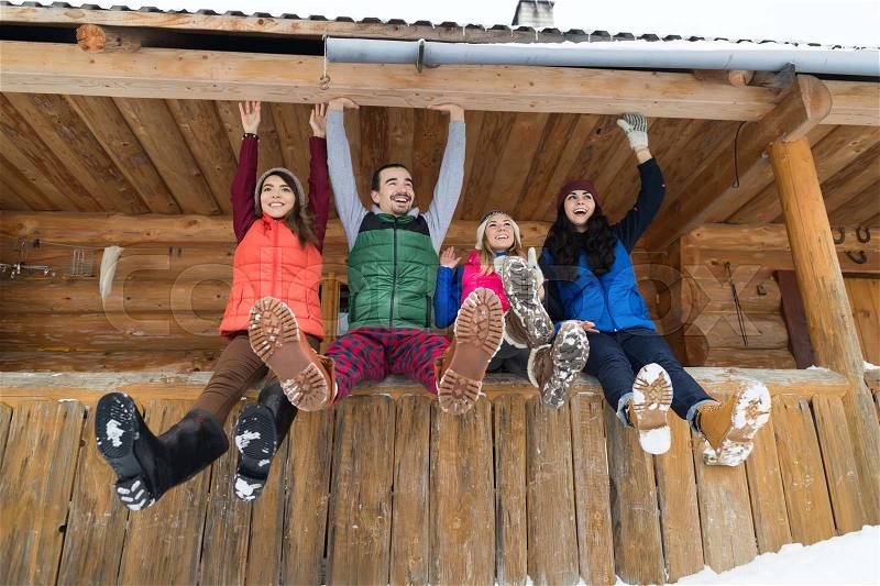 People Group Sitting On Terrace Wooden Country House Winter Snow Resort Cottage Friends Communication Vacation, stock photo