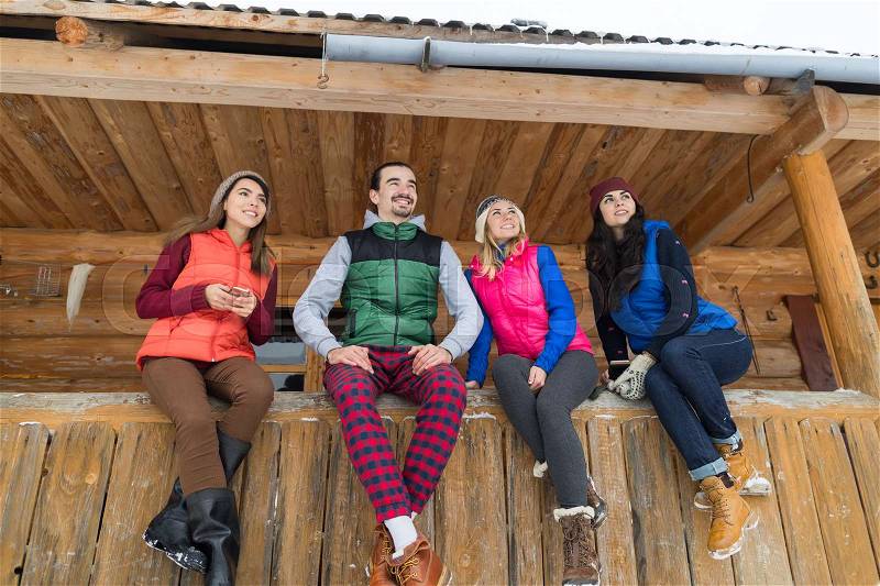 People Group Sitting On Terrace Wooden Country House Winter Snow Resort Cottage Friends Communication Vacation, stock photo