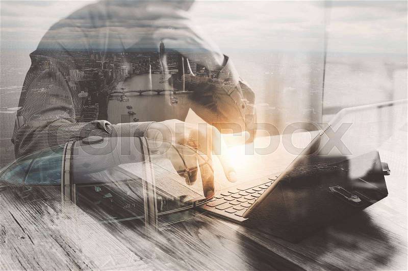 Double Exposure,businessman working with new start up project.using smart phone digital tablet docking smart keyboard on wooden desk,sun effect, stock photo
