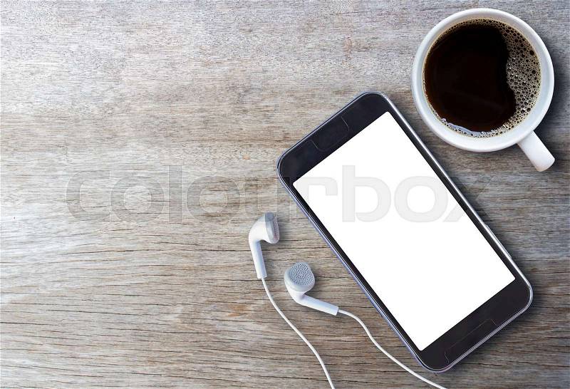 Smart phone and earphone with cup of coffee on old wooden background with copy space. top view, stock photo