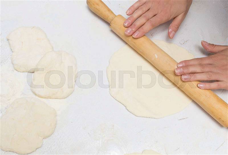 Rolling dough with a rolling pin, stock photo