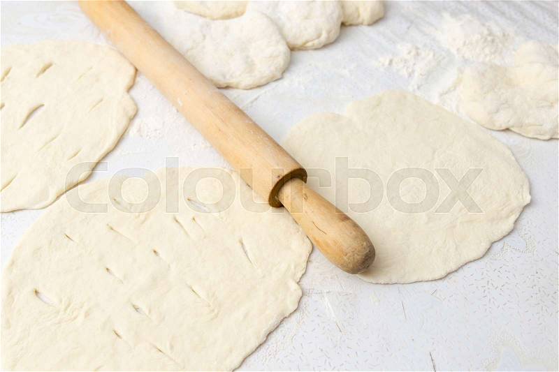 Rolling dough with a rolling pin, stock photo