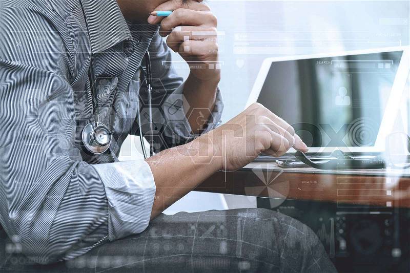 Smart medical doctor hand working with smart phone,digital tablet computer,stethoscope eyeglass,on wood desk, stock photo