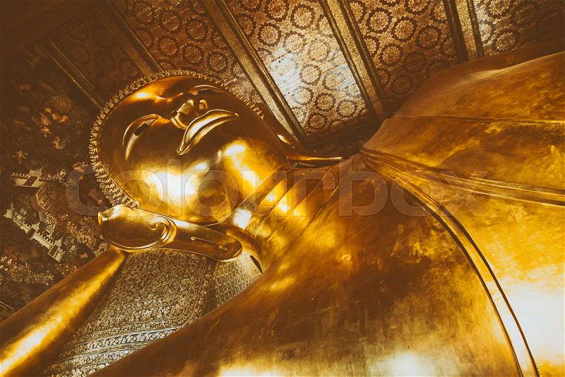 Reclining Buddha gold statue face. Wat Pho, Bangkok, Thailand, stock photo