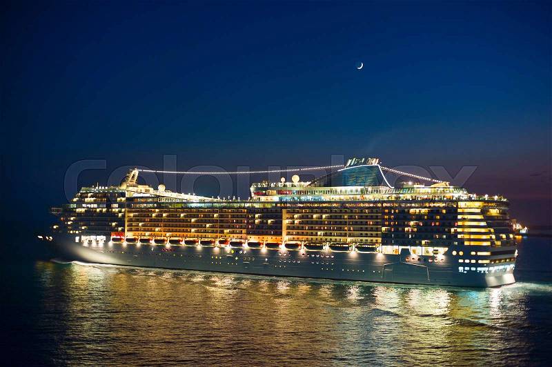 Cruise liner at night under the new moon, stock photo