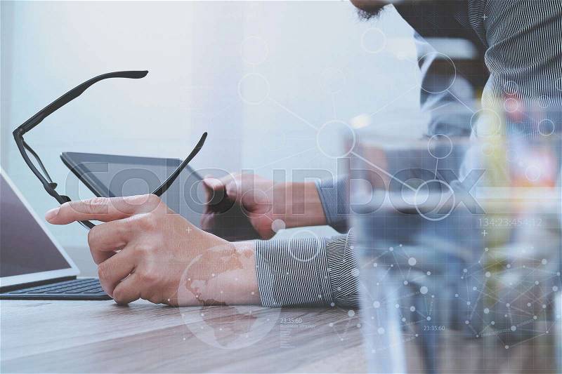 Website designer holding eyeglass working computer laptop,digital tablet on wood table,digital screen graphic virtual icons,graph,diagram , stock photo