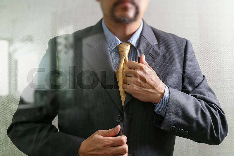 Businessman adjusting tie,Front view, no head. Concept of working in an office.filter effect, stock photo