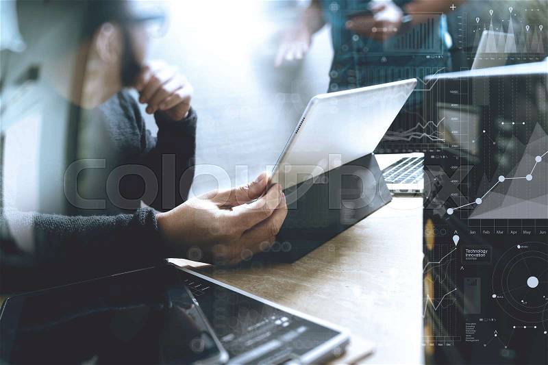 Co working process, entrepreneur team working in creative office space. using digital tablet docking keyboard and laptop with smart phone on marble desk,light beam effect, stock photo