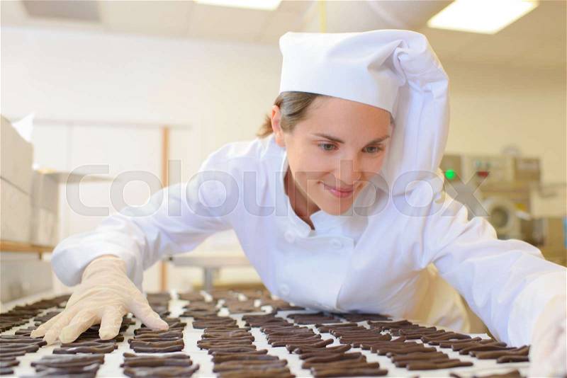 Chef organising chocolates, stock photo