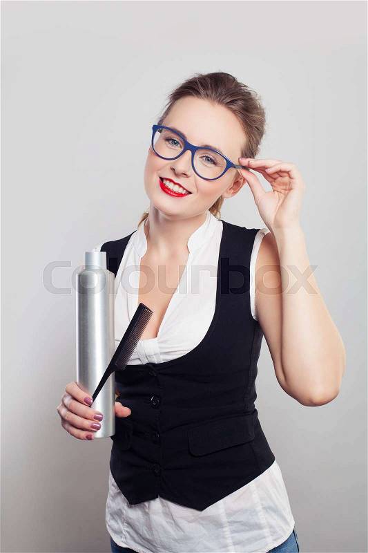 Smiling Woman Barber or Hairdresser with Hairspray and Comb, stock photo