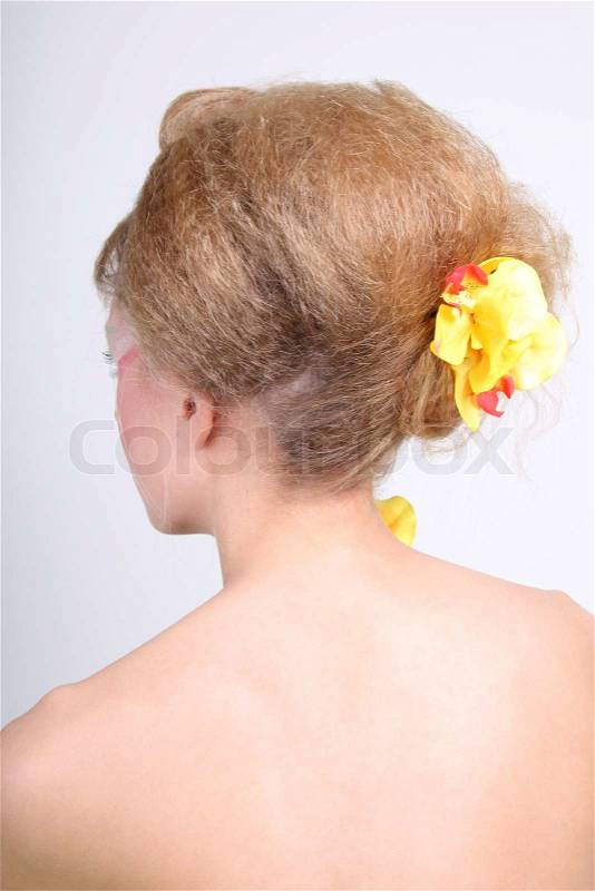 Woman's back with coiffure and yellow flowers, stock photo