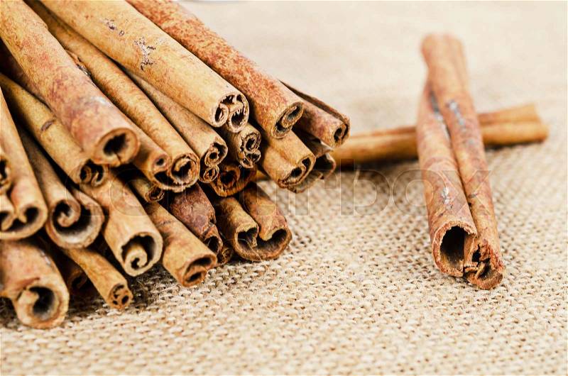 Cinnamon sticks on sack background, stock photo
