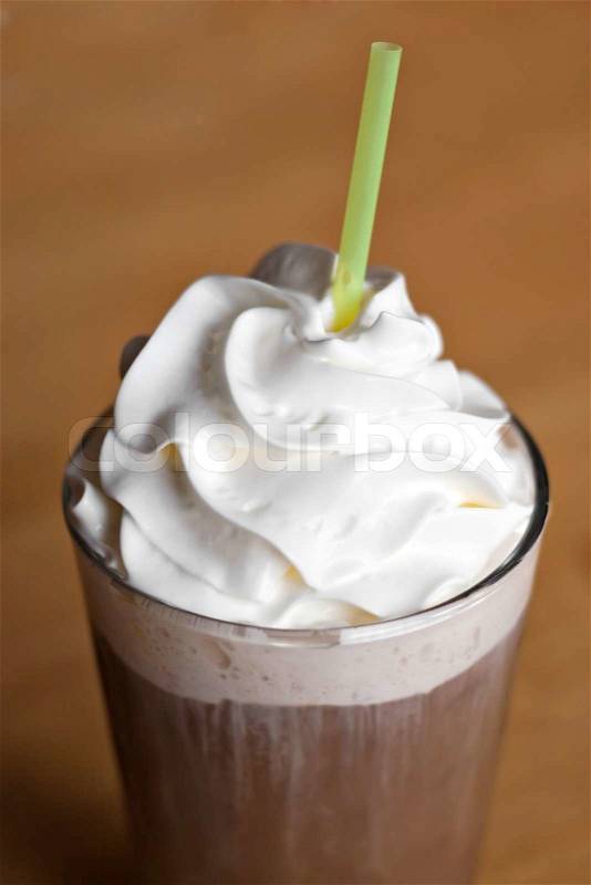 A delicious iced coffee drink topped with fresh whipped creamShallow depth of field, stock photo