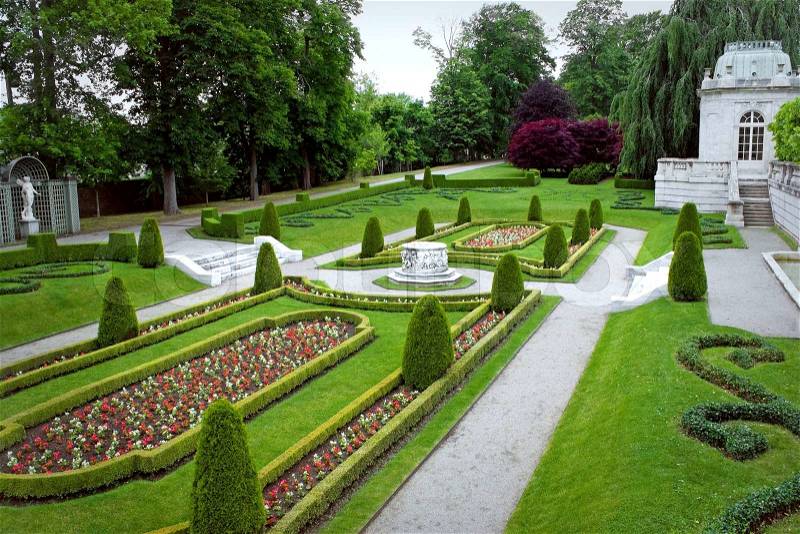 A fancy landscaped park or garden with flowers and highly groomed hedges, stock photo