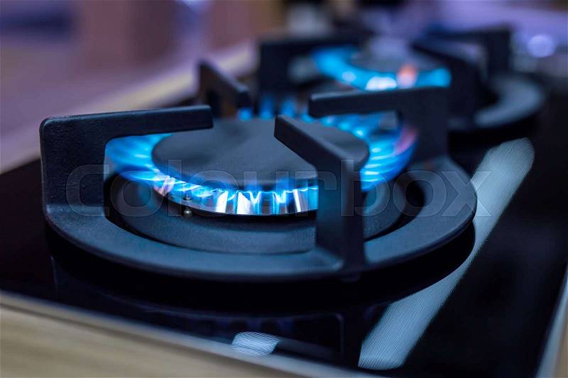Stove. Cook stove. Modern kitchen stove with blue flames burning, stock photo