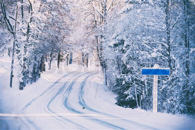 Road sign on winter road, empty. Stylised picture, stock photo