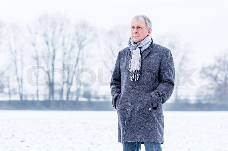 Depressed or sad man walking in winter, stock photo