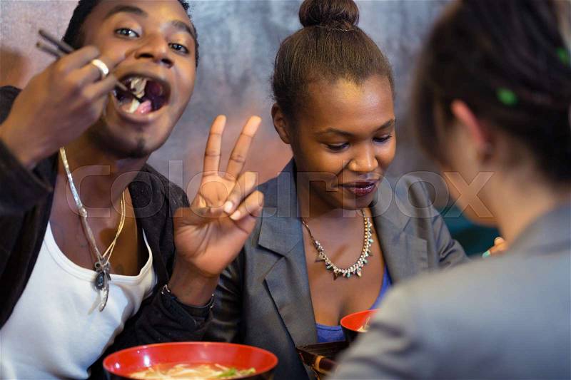 Group of young black people dining in Asian restaurant, stock photo