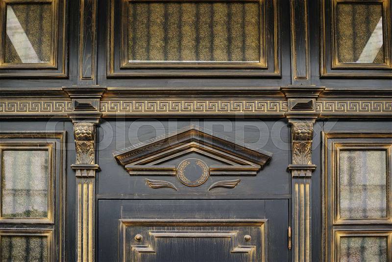 Wood carving with arch above the door in an old building, stock photo