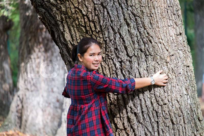 Asian woman hug big tree with smile-eco concept, stock photo