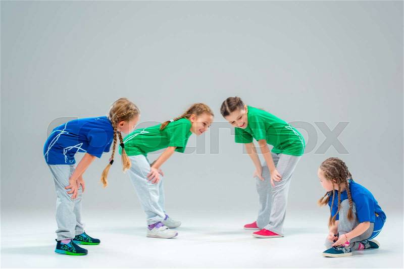 The kids dance school, ballet, hiphop, street, funky and modern dancers on gray studio background, stock photo
