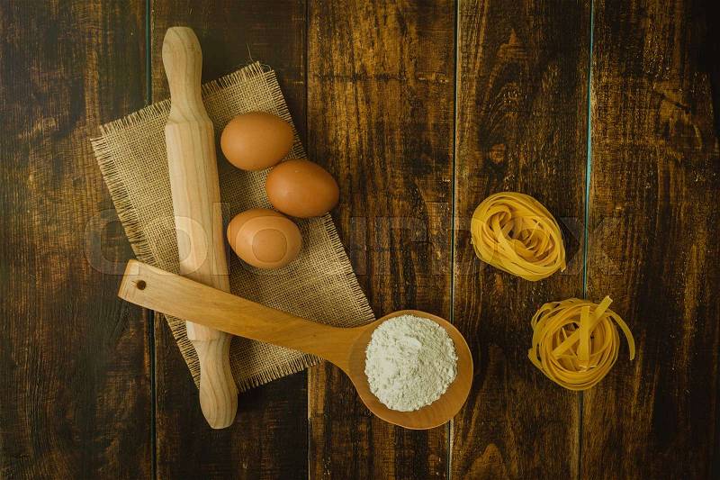 Ingredients for cooking pasta on rustic wood, stock photo